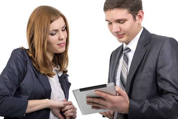 Man and woman looking at a tablet together.
